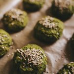 Delicious spinach falafels topped with sesame seeds, baked to perfection on a tray in Erfurt, Germany.