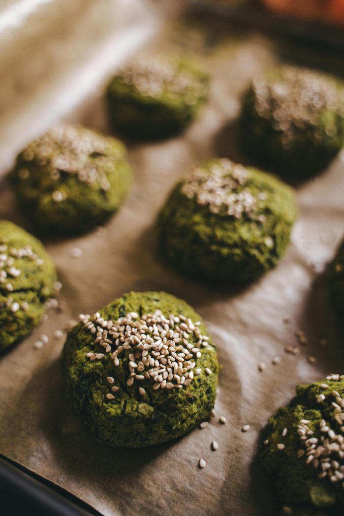 Delicious spinach falafels topped with sesame seeds, baked to perfection on a tray in Erfurt, Germany.